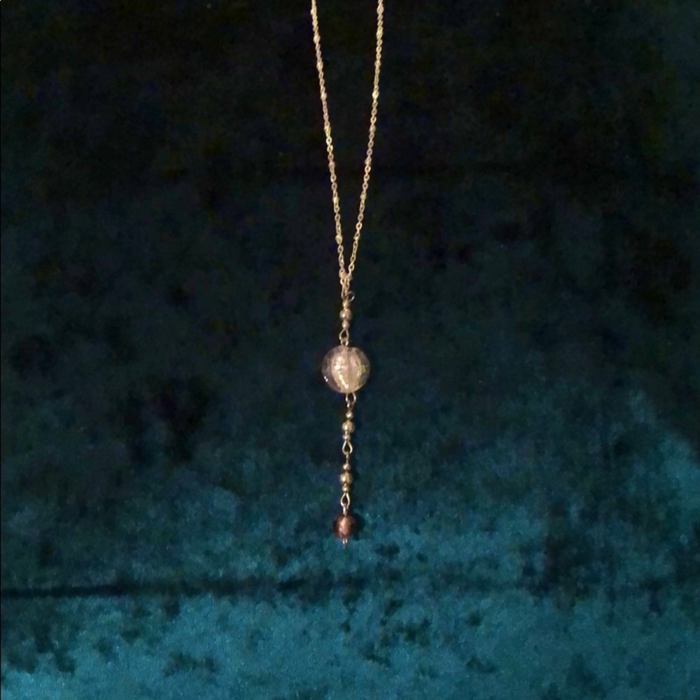 Handmade glass bead on handmade necklace.